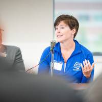 An Alumni speaking to the group at the event.